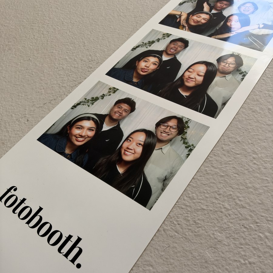 A fotobooth. photo strip print laid out on the floor